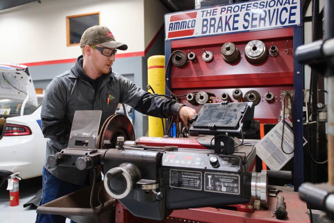 Central Garage at work - Gallery image A mechanic at work with a brake servicing machine