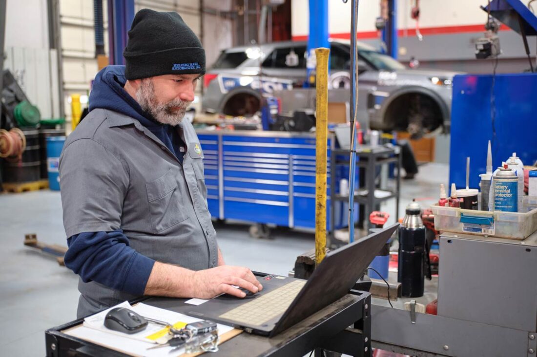 Central Garage at work - Gallery image A mechanic using a laptop for diagnostic work