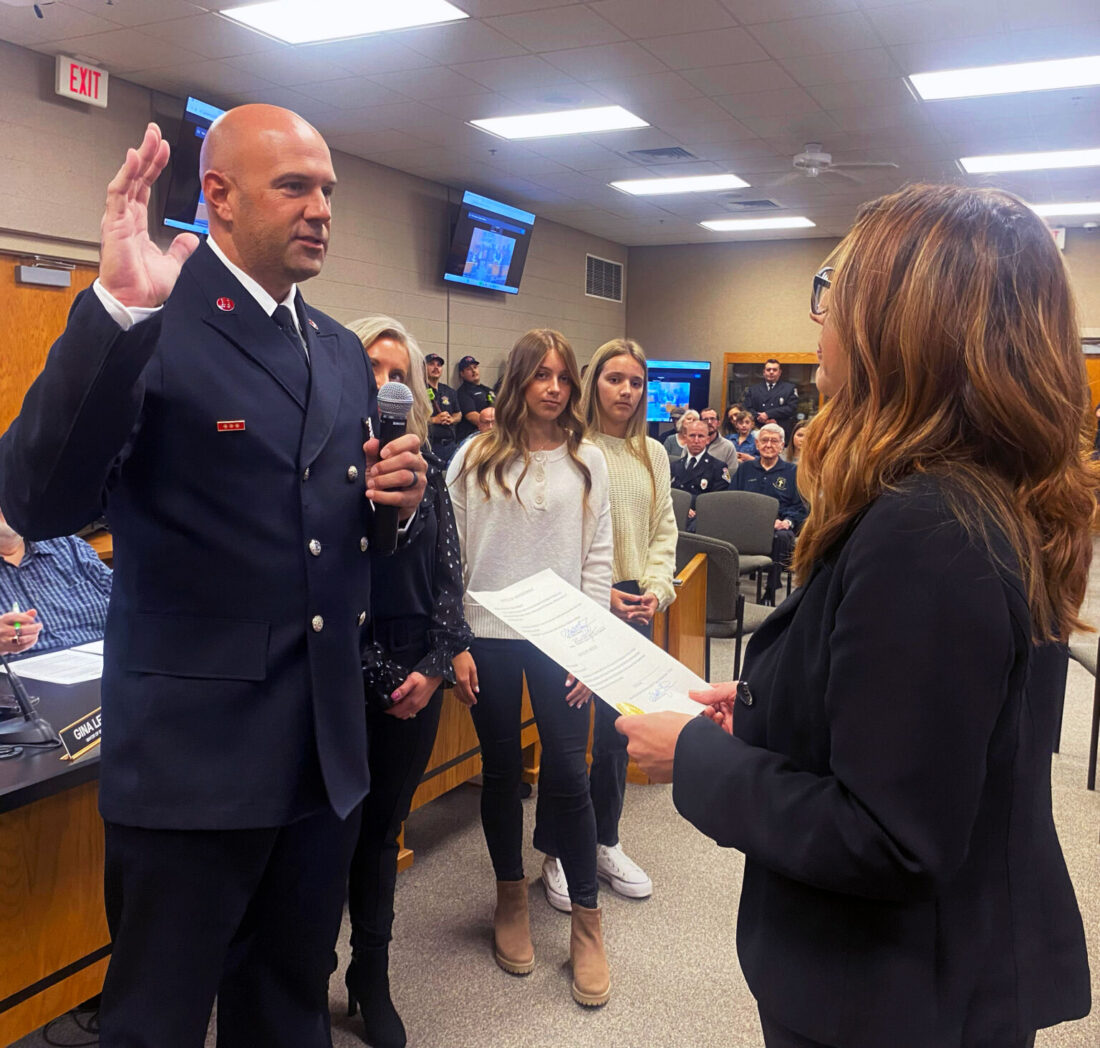 Photo of Mayor Gina Leichty swearing in Phil Schrock for his Assistant Chief role at Goshen Fire Department