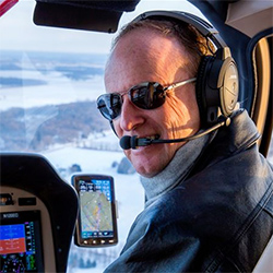 An interior photo of Randall Sharkey piloting an aircraft.