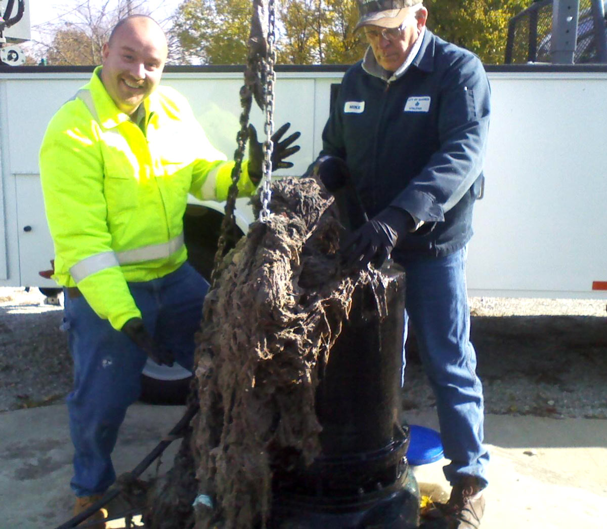 Two staff members pulling debris from a station