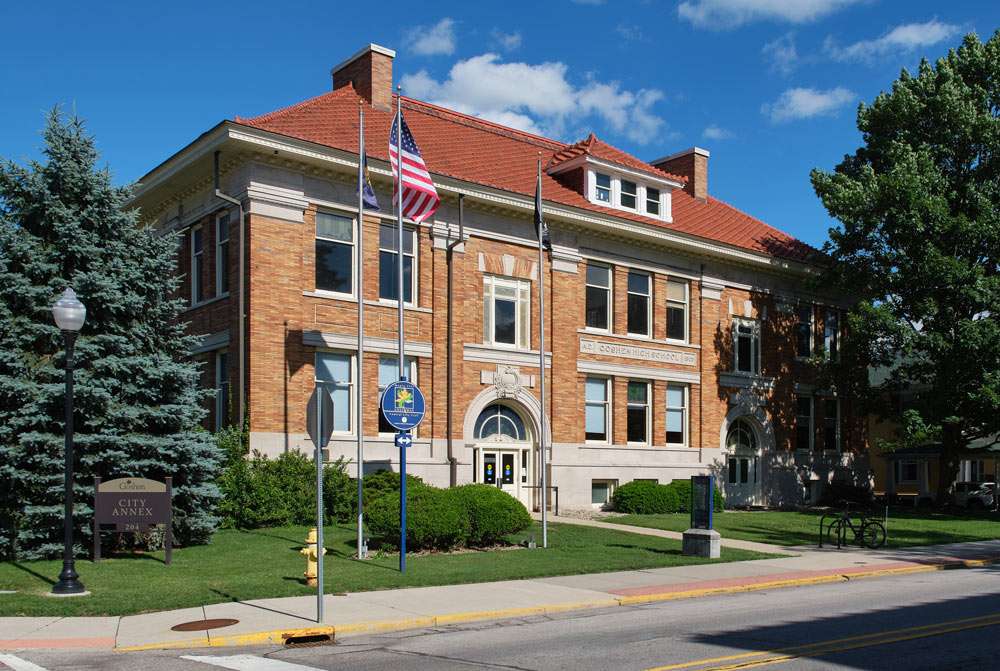 An exterior photo of the Annex Building, a beautiful brick building with a red tile roof