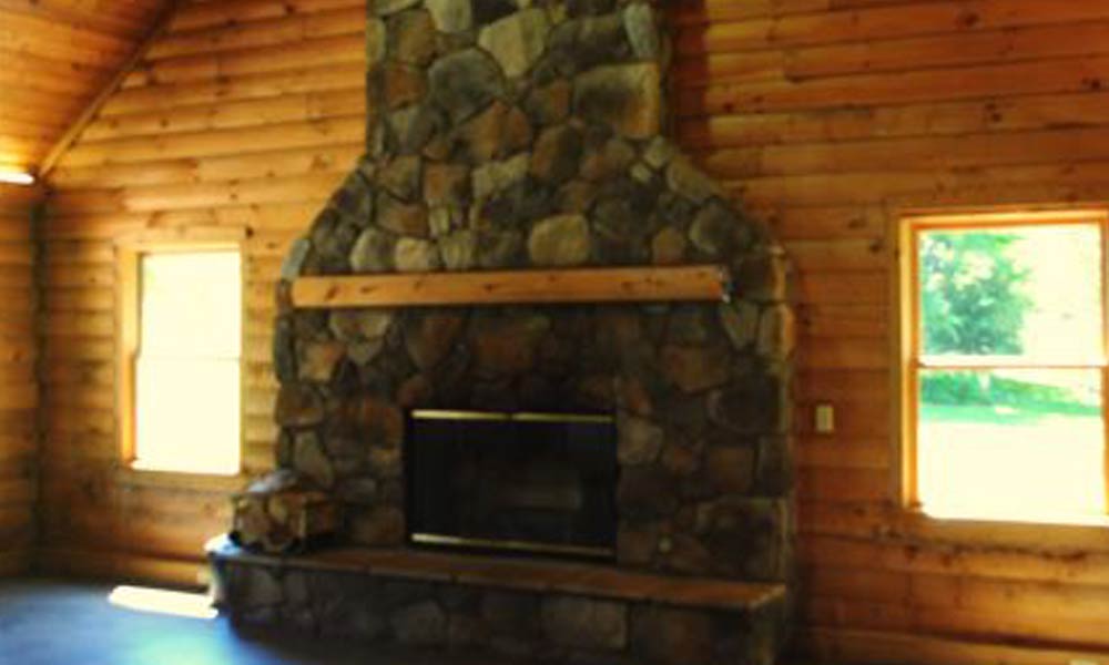 An interior of the cabin showing the stone fireplace