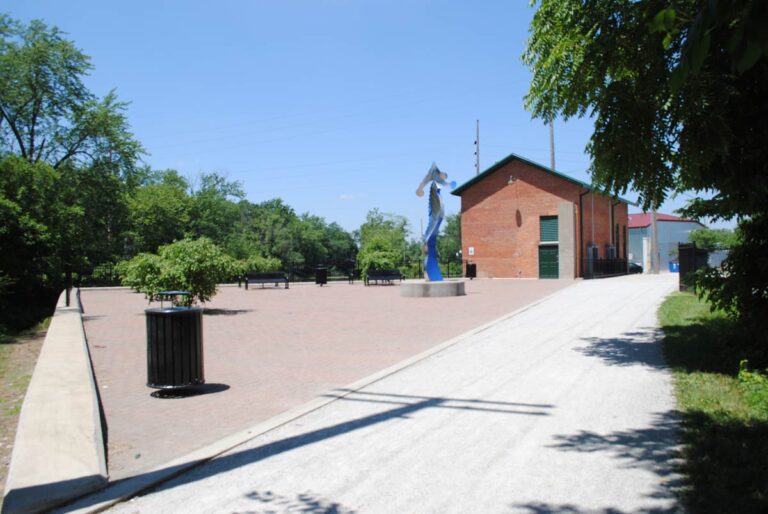 A view looking north at the park patio and John Mishler sculpture