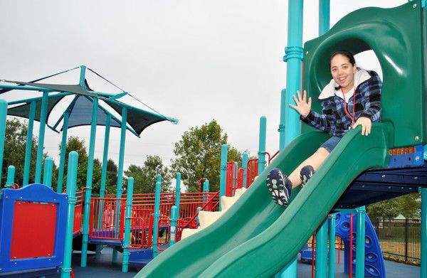 A photo of a girl going the slide of Kerry's Kids Playground in Hay Park.