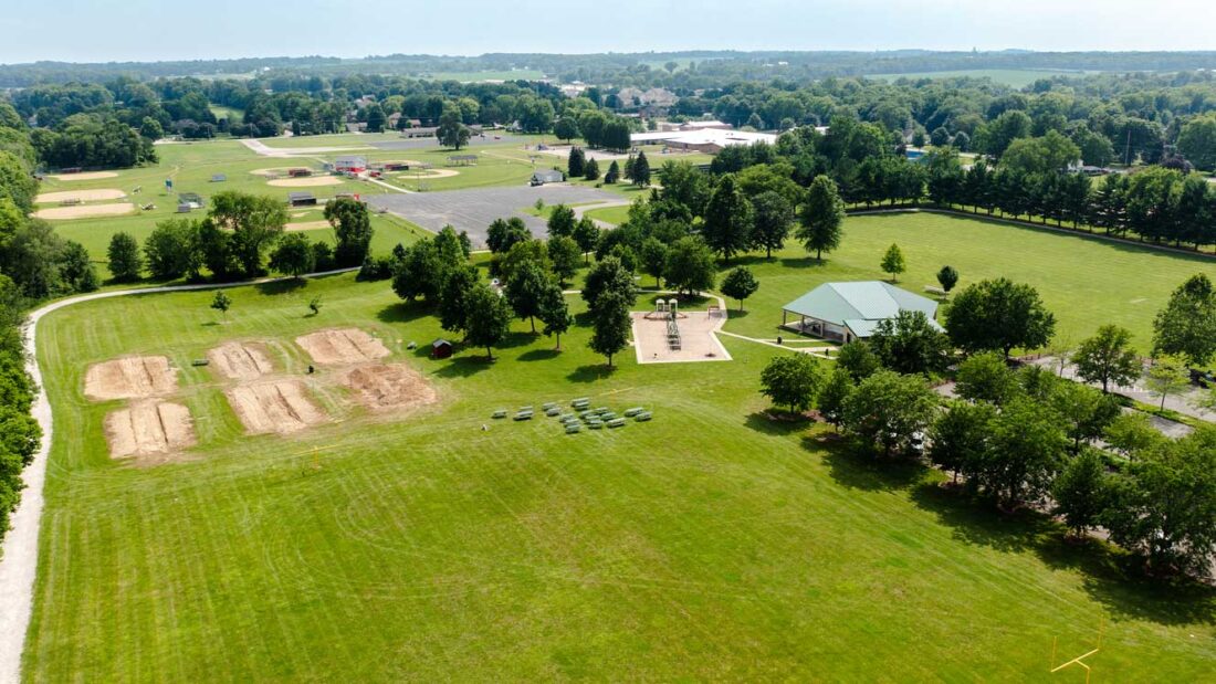 An aerial photo showing Pringle Park's football, volleyball, and soccer fields, splash pad, playground, and Fidler Pavilion.