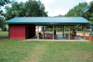 A photo of a family enjoying a summer day at Rieth Park's pavilion and playground.