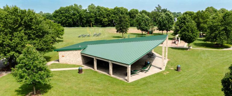 An aerial photo of Fidler Pavilion on a sunny day with its playground, splash pad, and sporting fields behind it.